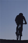 A cyclist silhouetted against the sky