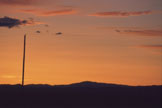 An orange evening sky above distant hills