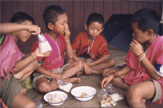 People sharing a meal around bowls of food