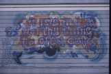 A painted mural on a corrugated wall