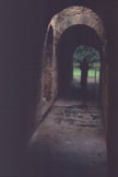 A narrow passage framed by rounded arches