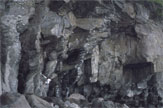 A climber among angular grey rocks