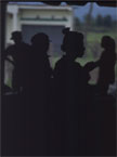 People silhouetted in an open doorway