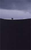 Small walkers crossing a dark ridge