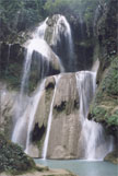 Water cascading over pale rock terraces